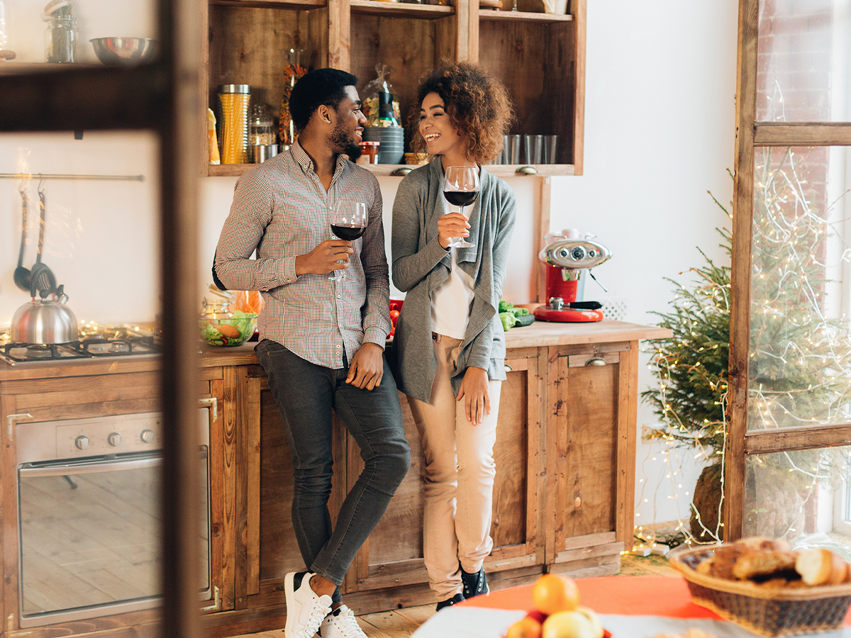 Couple smiling and enjoying a clean kitchen decorated for holidays