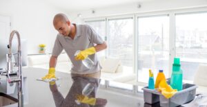 Man cleaning kitchen countertops