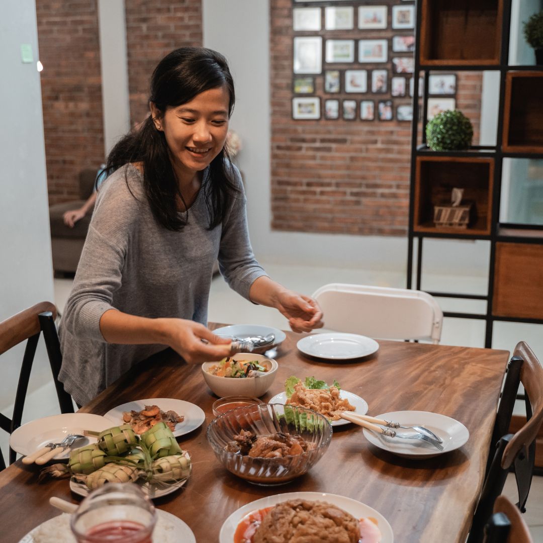 woman setting table for dinner