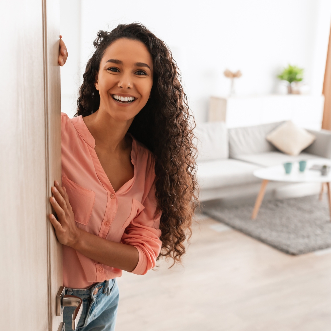 woman welcoming guests into her house